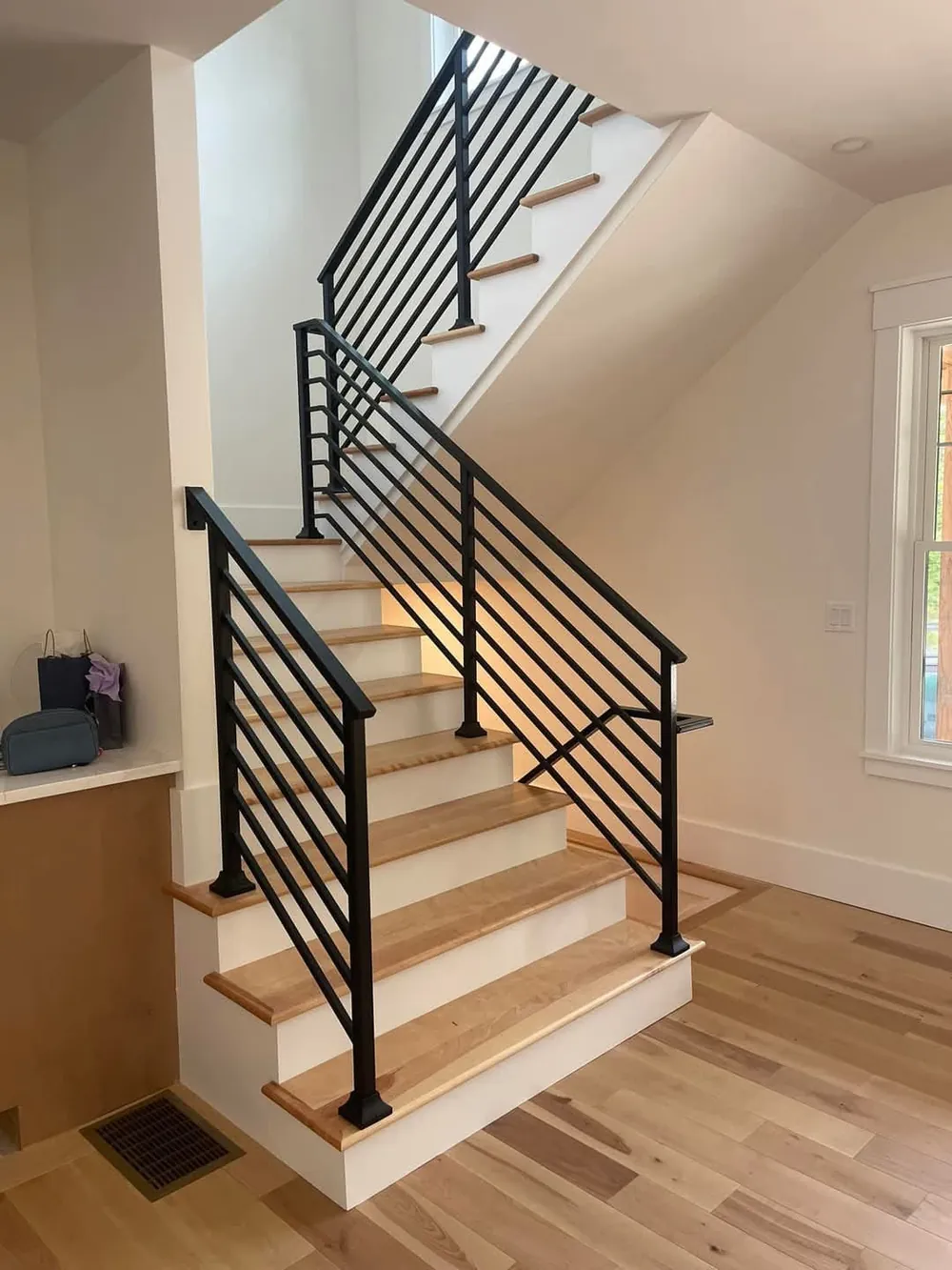 Black interior stair railing on oak stairs