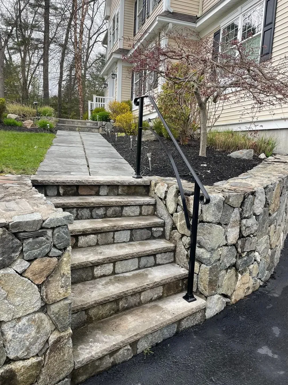 Curved handrail on fieldstone steps